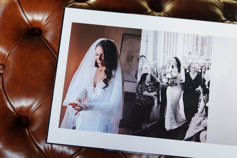 Two wedding photographs displayed on brown leather upholstery show a bridal portrait and a reception celebration scene.