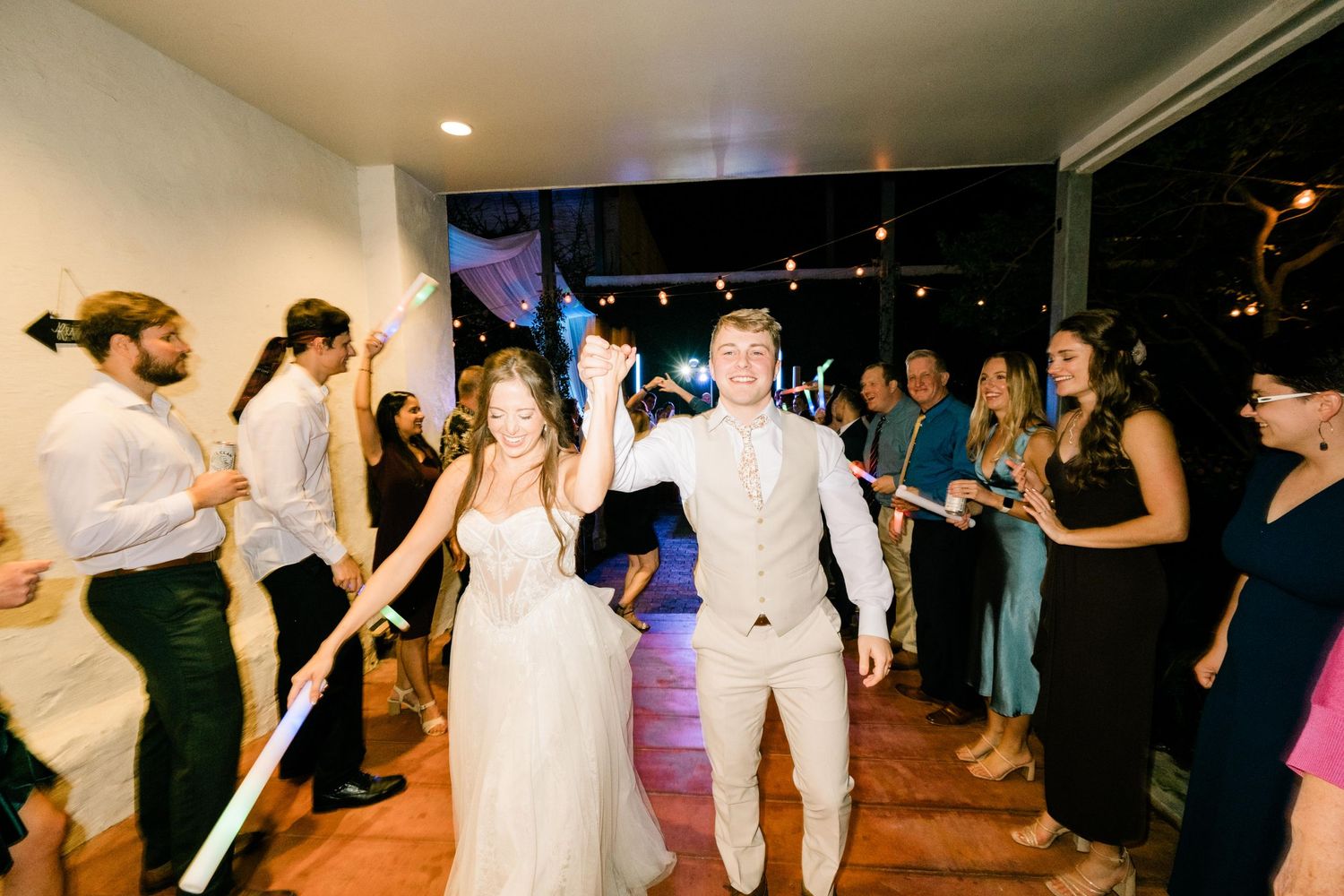 Wedding reception dance floor with guests celebrating in an indoor venue.