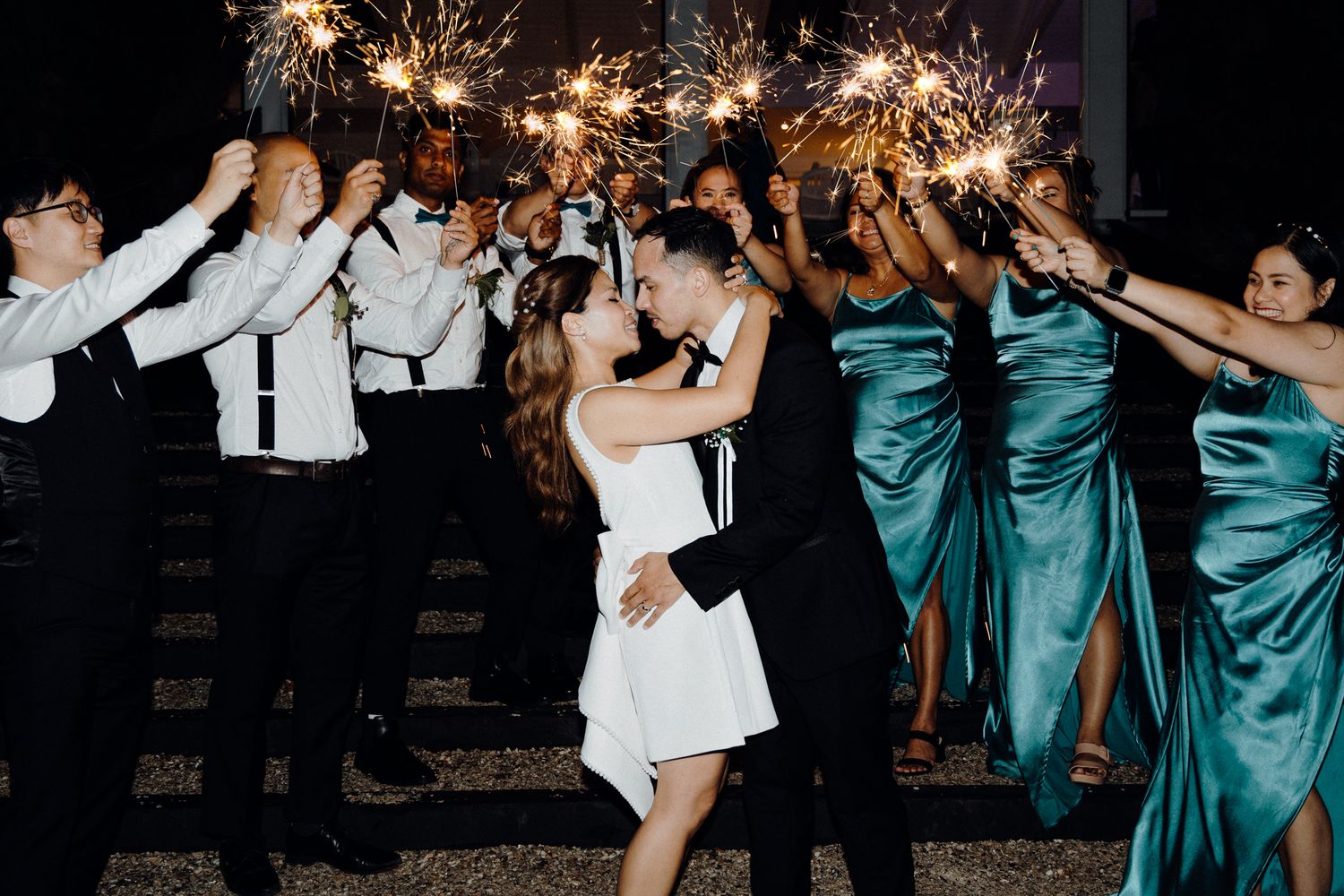 Wedding party celebrates with sparklers captured by Apertured Media Auckland Wedding Photographer.