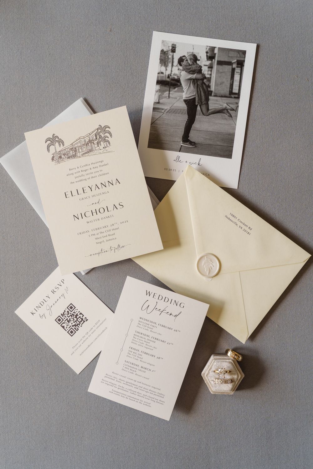 Elegant wedding invitation suite with letterpress details, polaroid photo, and wax seal on gray background.