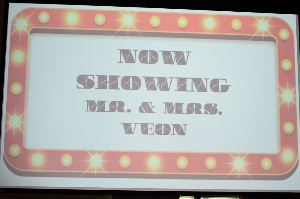 Pink and white polka dot carnival-style signage with retro typography displays event information against a white background.