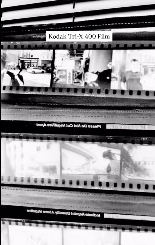 Black and white film negatives strip showing frames of developed Kodak Tri-X 400 photographic film.