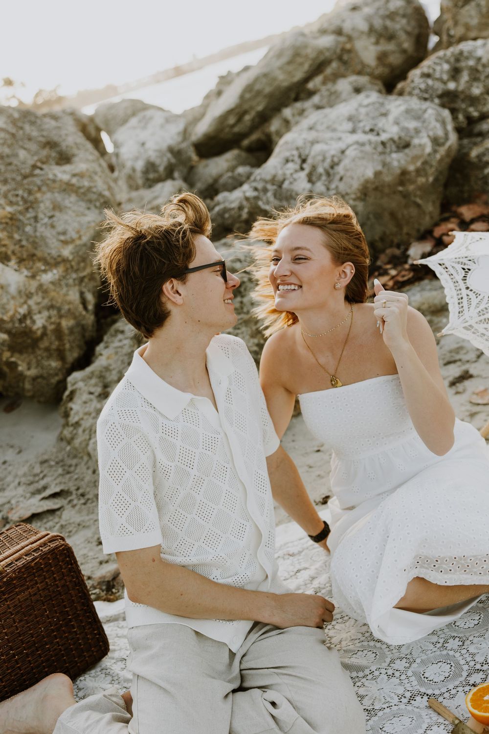 Golden Hour engagement photos of a couple having a beach picnic at Dubois Park in Jupiter, Florida captured by Lindsay McDow Photography