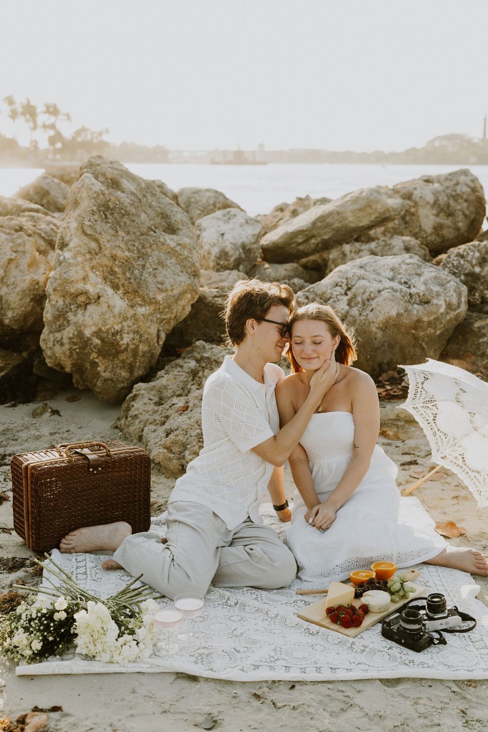 Golden Hour engagement photos of a couple having a beach picnic at Dubois Park in Jupiter, Florida captured by Lindsay McDow Photography