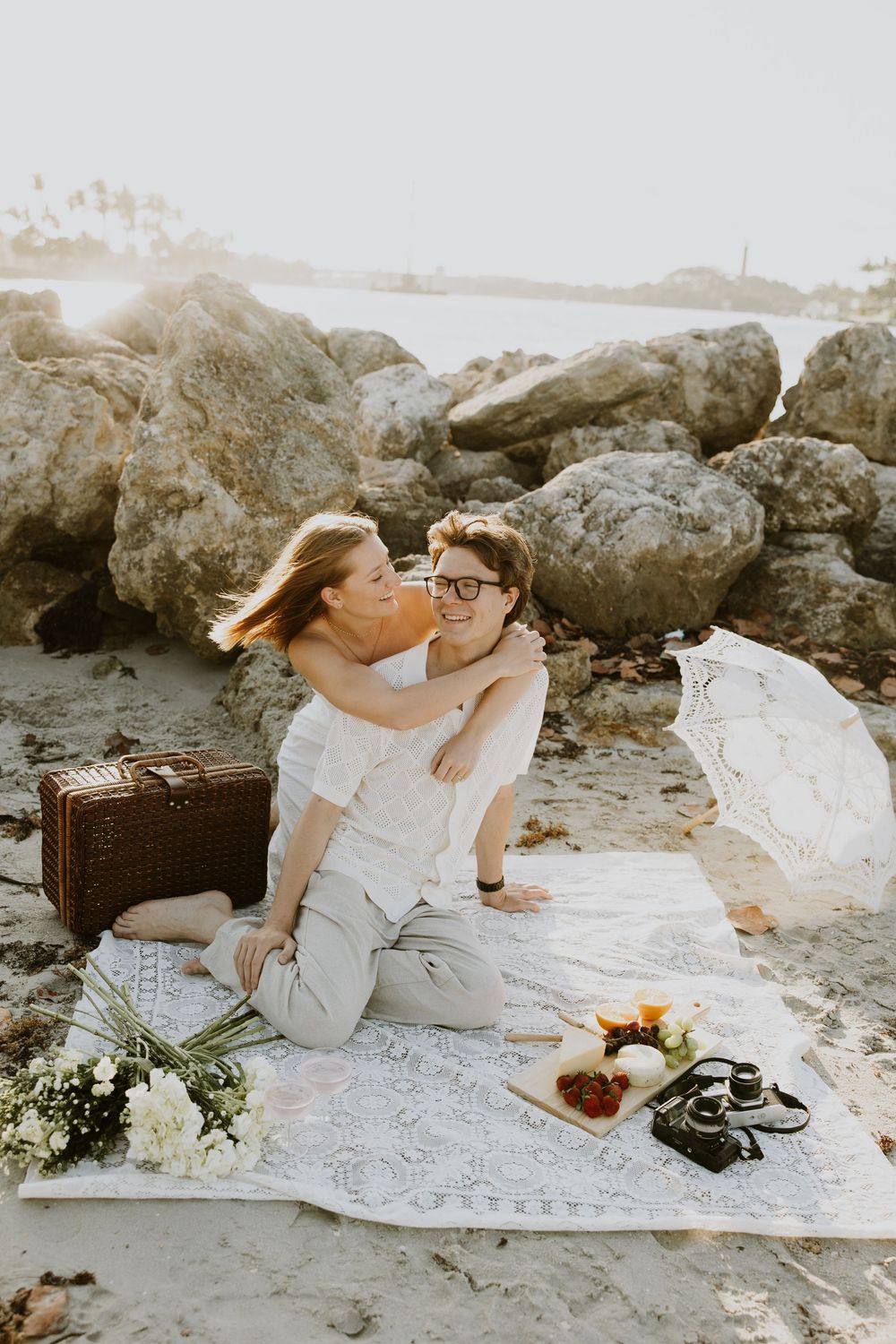 Golden Hour engagement photos of a couple having a beach picnic at Dubois Park in Jupiter, Florida captured by Lindsay McDow Photography