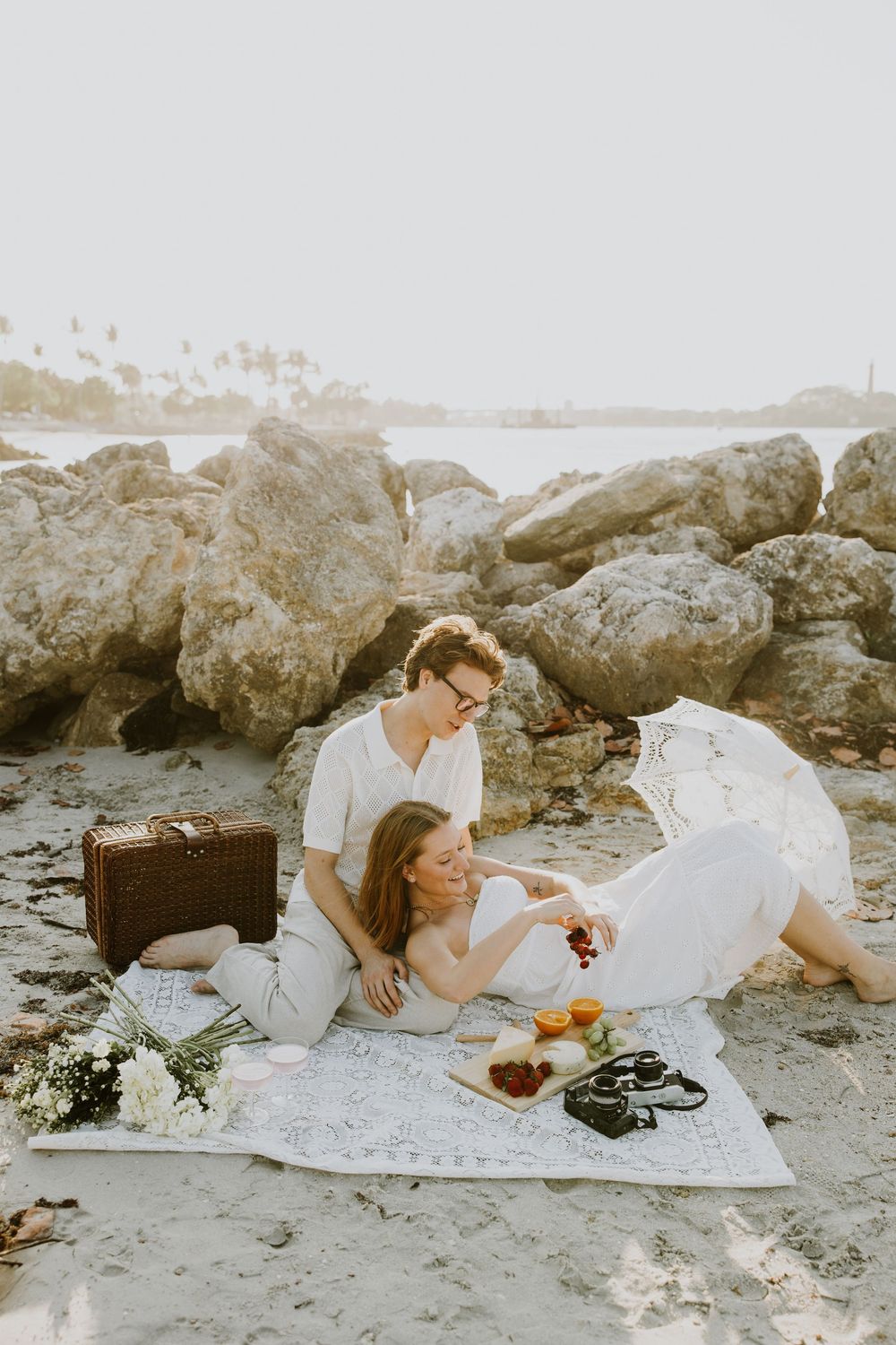 Golden Hour engagement photos of a couple having a beach picnic at Dubois Park in Jupiter, Florida captured by Lindsay McDow Photography
