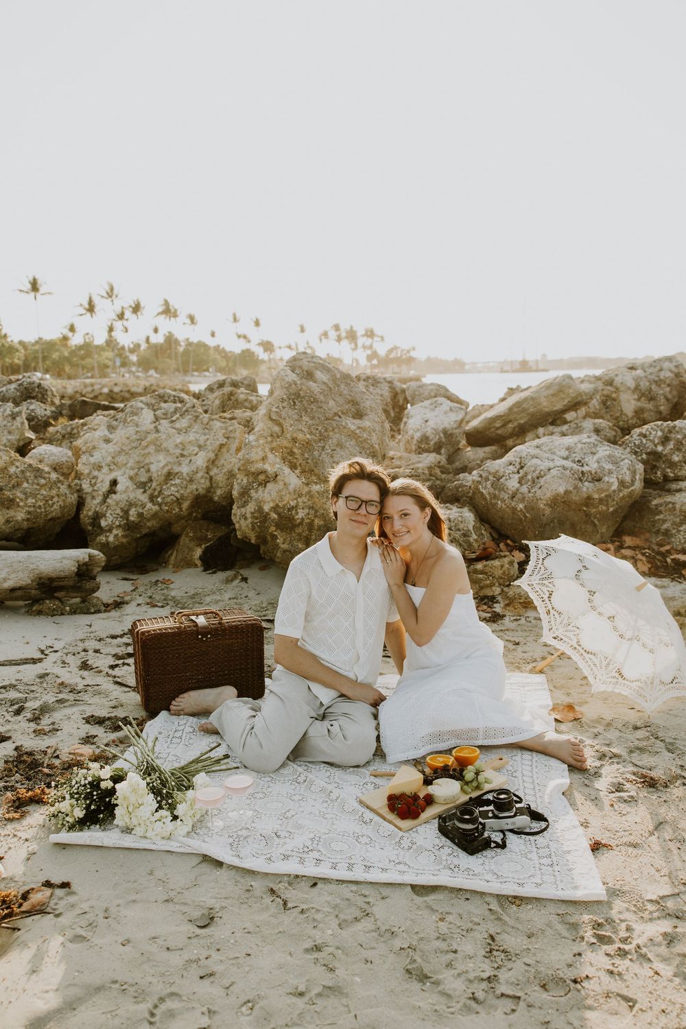 Golden Hour engagement photos of a couple having a beach picnic at Dubois Park in Jupiter, Florida captured by Lindsay McDow Photography