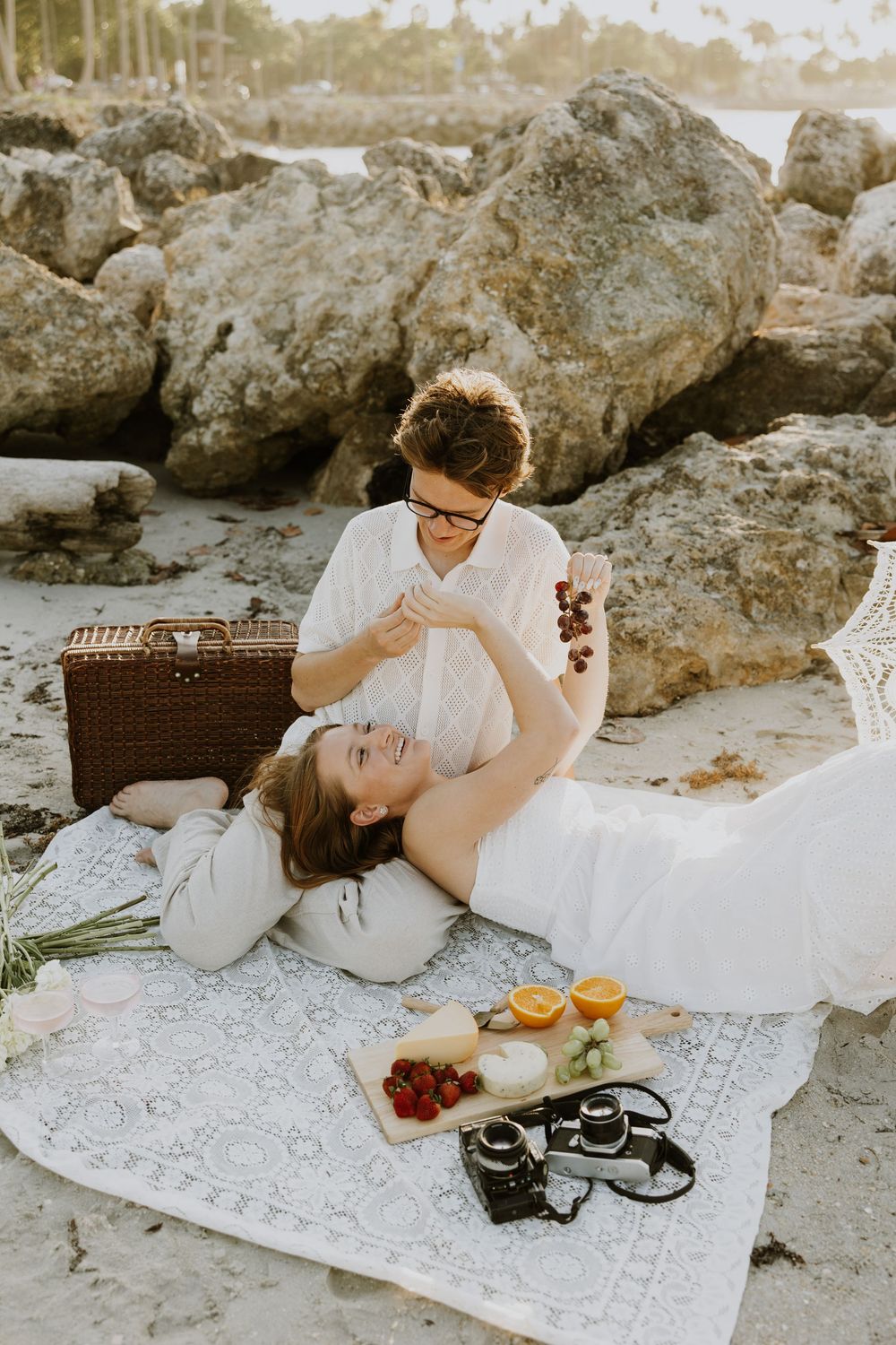 Golden Hour engagement photos of a couple having a beach picnic at Dubois Park in Jupiter, Florida captured by Lindsay McDow Photography