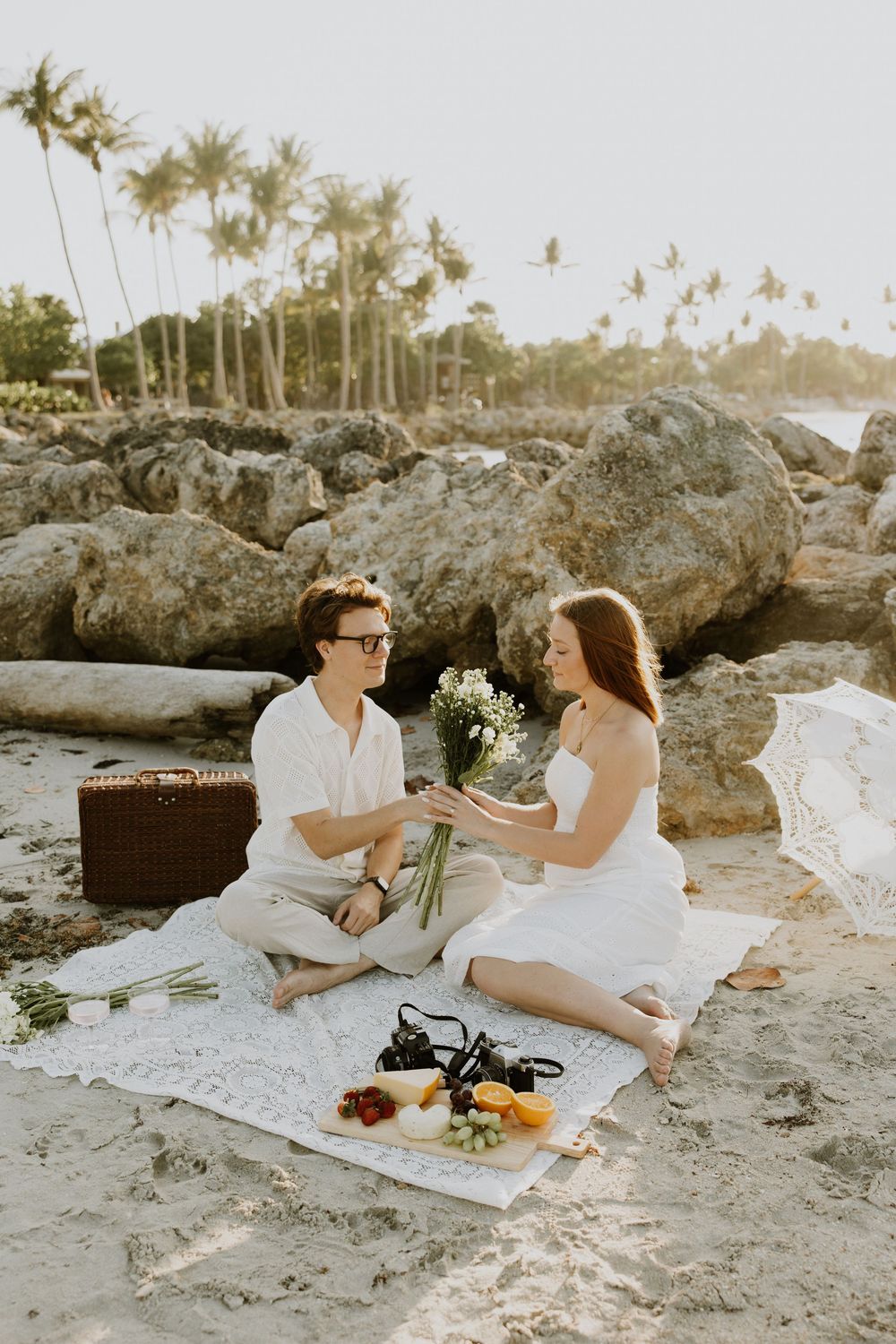 Golden Hour engagement photos of a couple having a beach picnic at Dubois Park in Jupiter, Florida captured by Lindsay McDow Photography