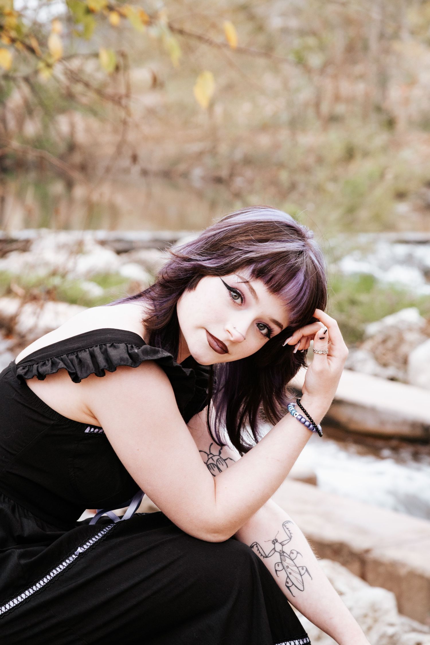 A portrait series with person in black attire posing against a snowy outdoor background with trees.