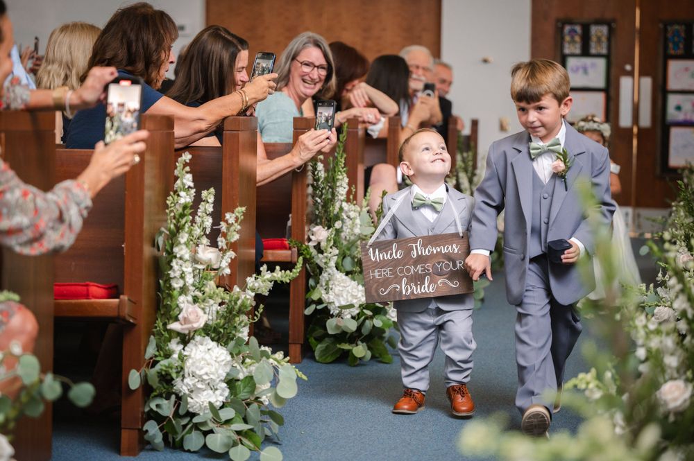 Wedding ceremony aisle decorated with white floral arrangements and greenery.Hudson Valley wedding