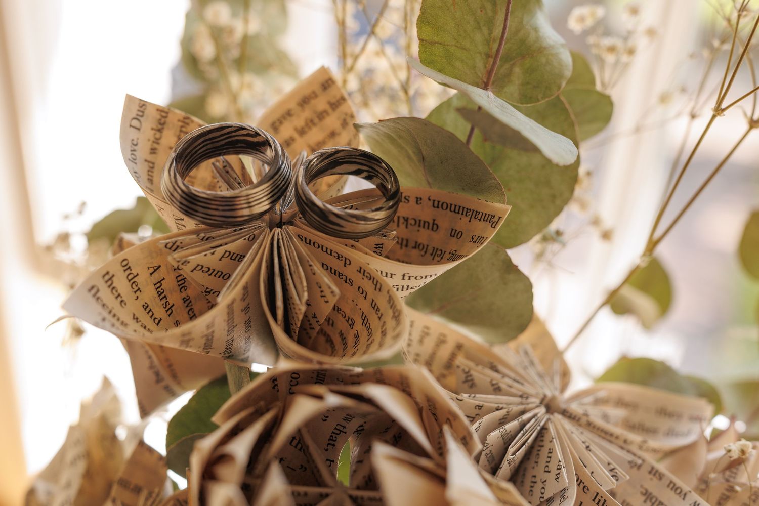 Paper origami decorations with delicate floral patterns in warm sunlight.