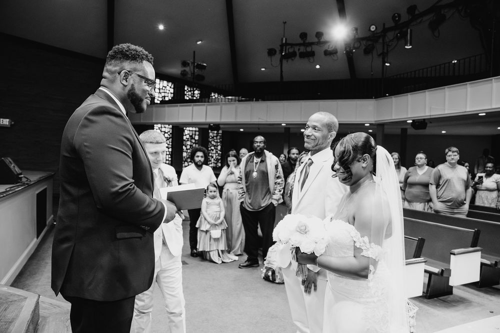 A series of black and white wedding reception photos showing guests and a couple dancing at an elegant indoor venue.