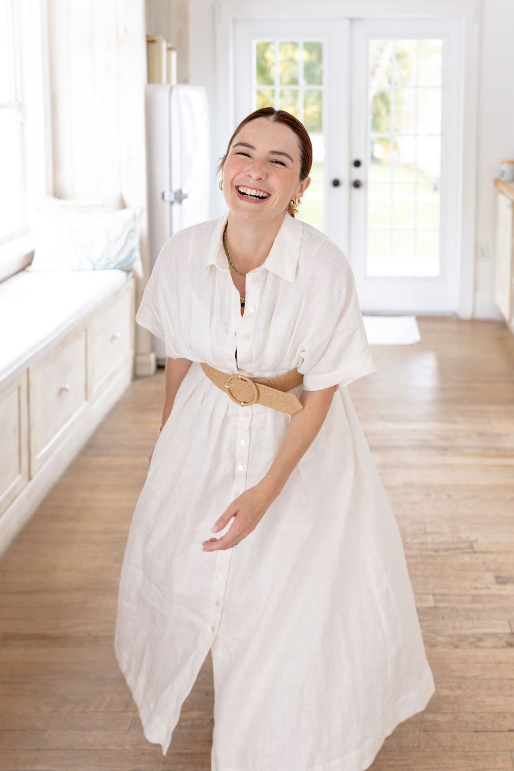 Series of photos showing someone in white flowing dress twirling and laughing joyfully on hardwood floors in sunlit room.