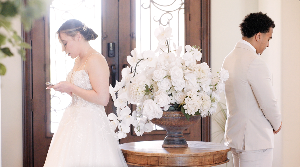 Wedding preparation scene with elegant white floral arrangement and formal attire.