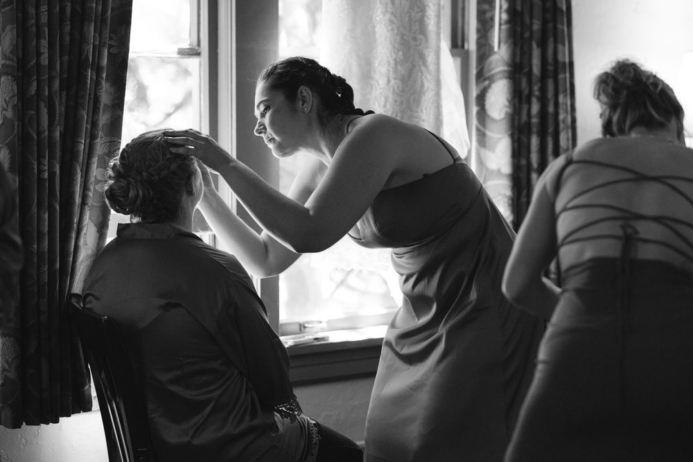 Wedding party silhouettes gathered together in an intimate indoor setting.