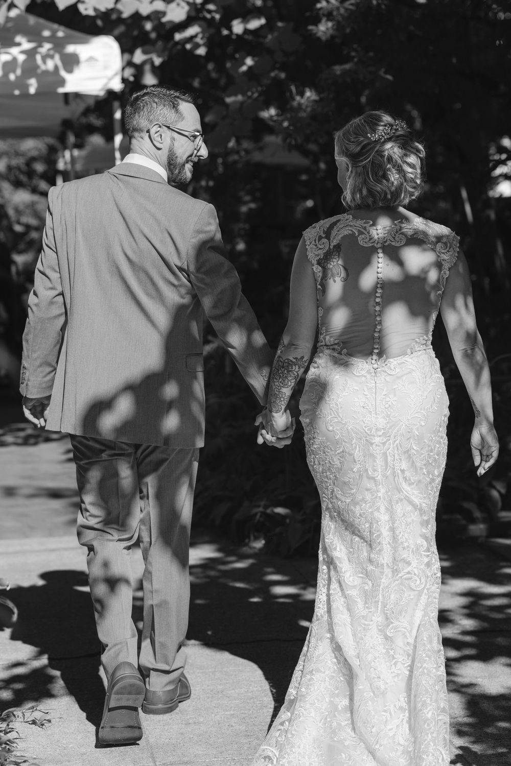 A black and white image series showing artistic wedding photo perspectives of a couple walking through dappled sunlight.