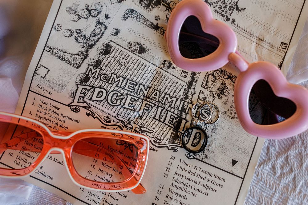 Vintage map detail with heart-shaped sunglasses and orange frames laid on top.