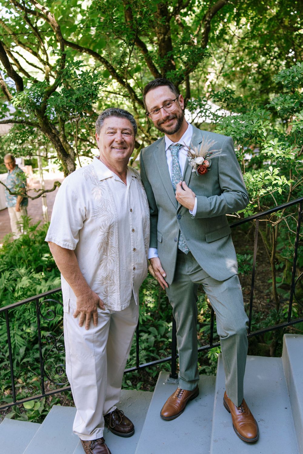 A lighthearted sequence of candid interactions between wedding guests outdoors near a garden railing on a sunny day.