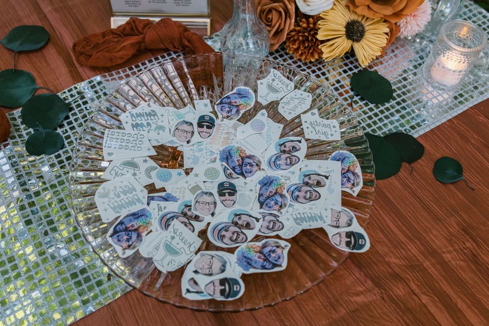Overhead view of decorative teacups arranged on a glass platter at a party.