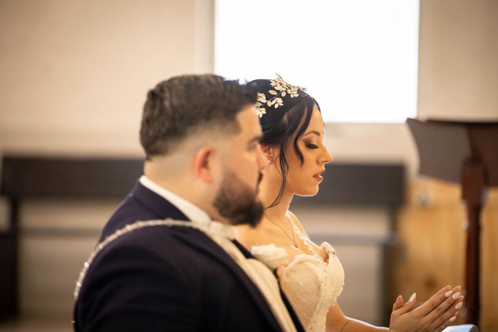 A couple shares an intimate moment during their wedding ceremony in a church setting.