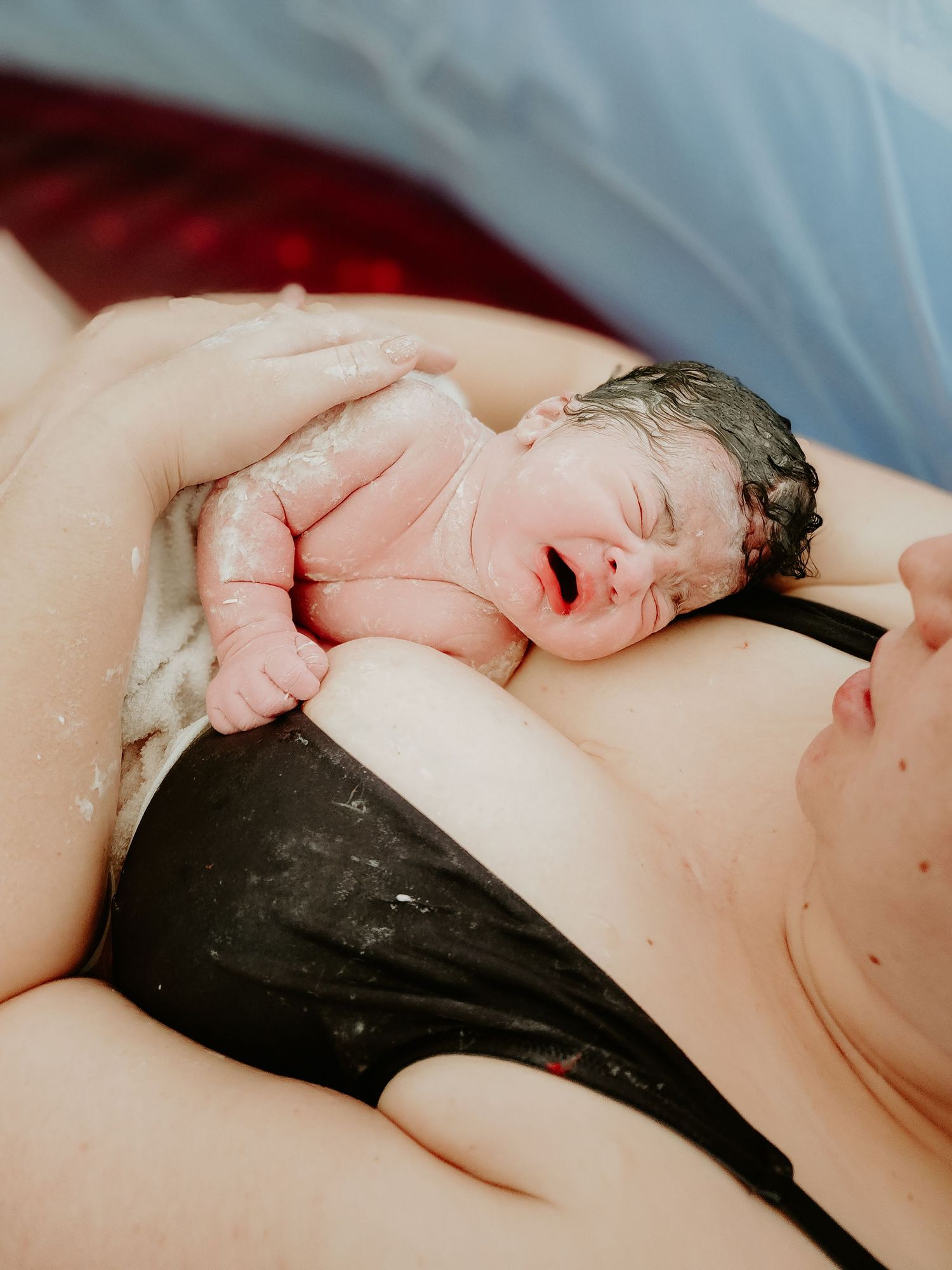 First moments of newborn life captured during skin-to-skin contact.