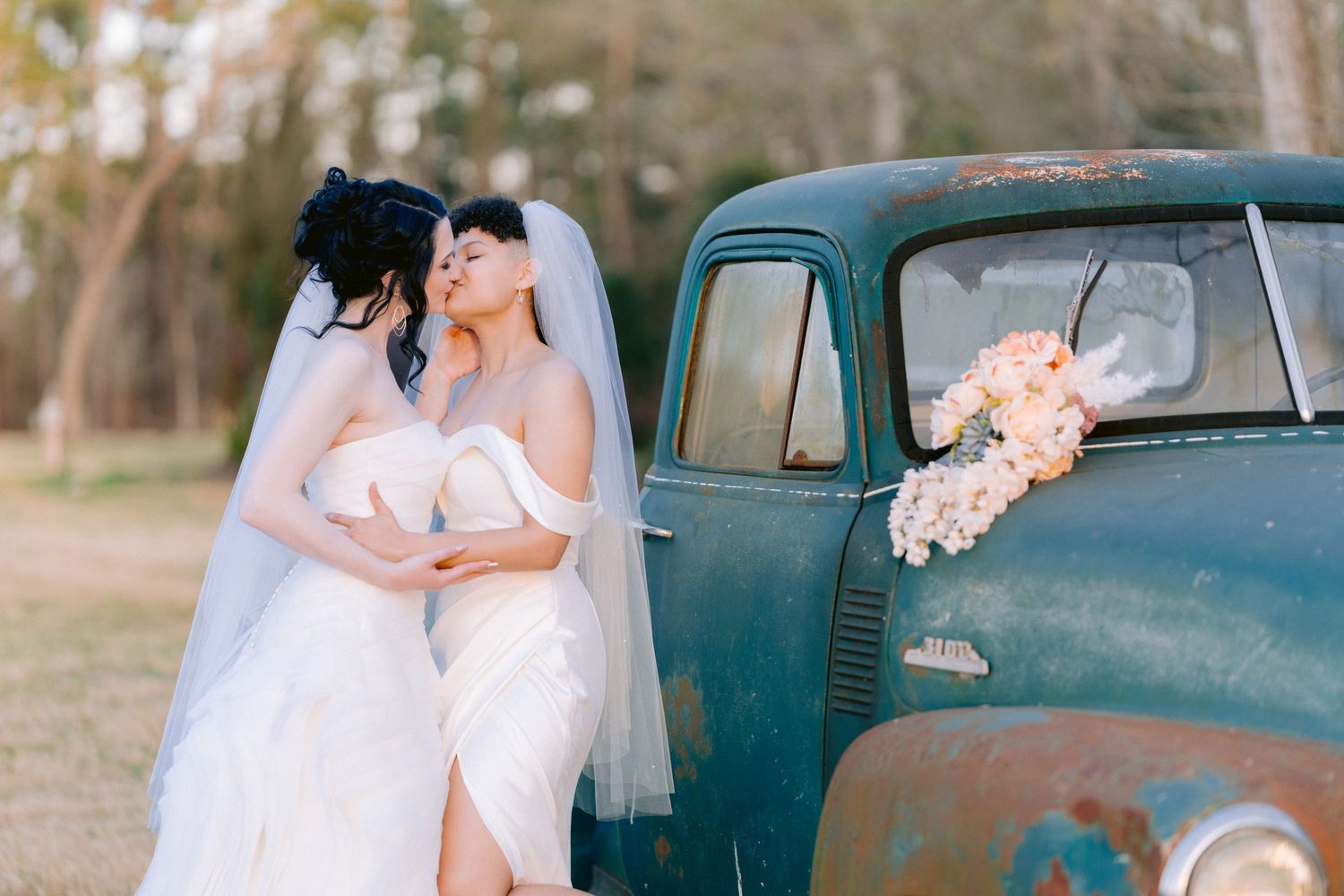 Photo by Sunset Bay Weddings, two brides kissing, rustic venue, tampa florida