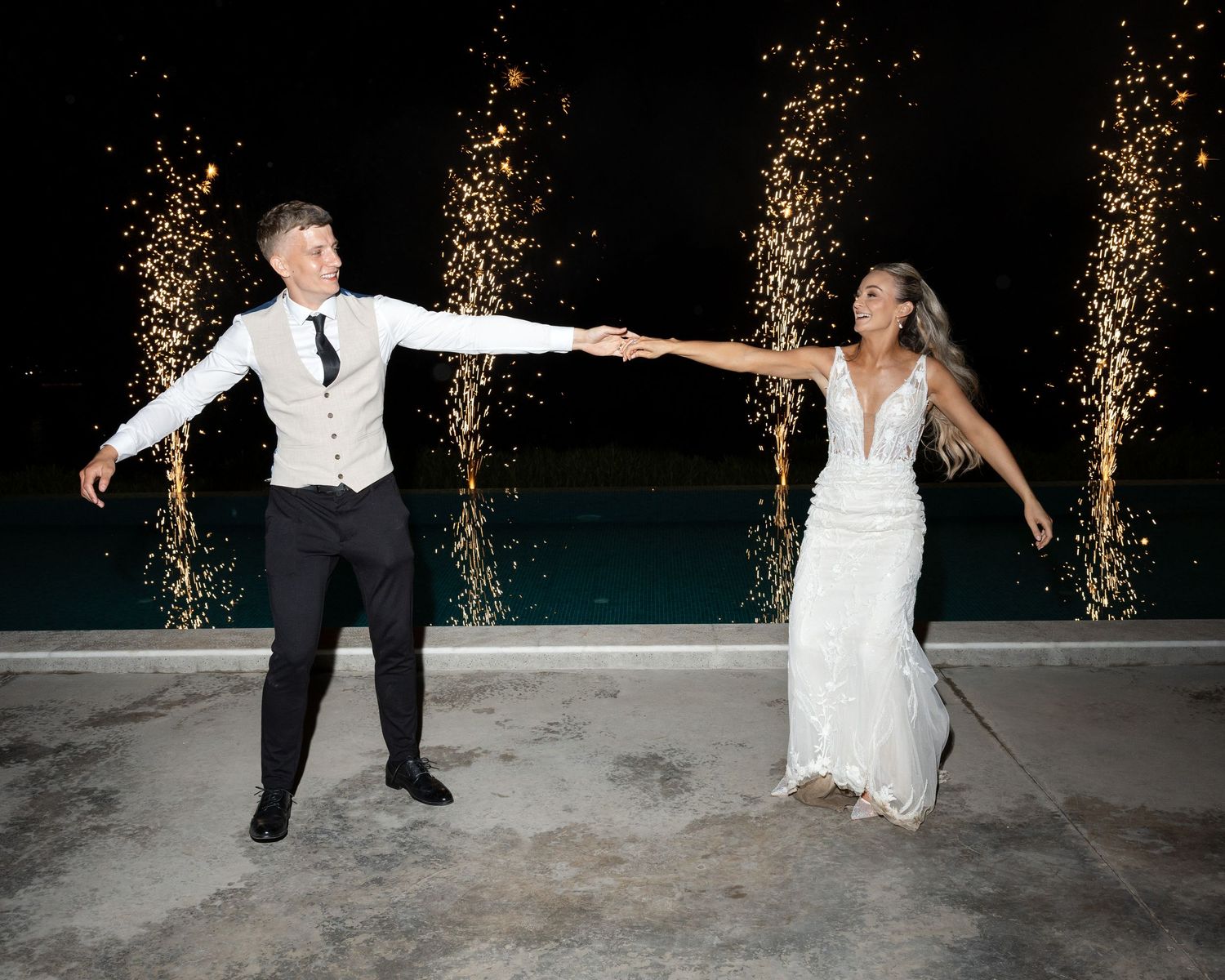 A sequence of dance moves captured at night with sparkling lights in the background shows a couple in formal attire performing.