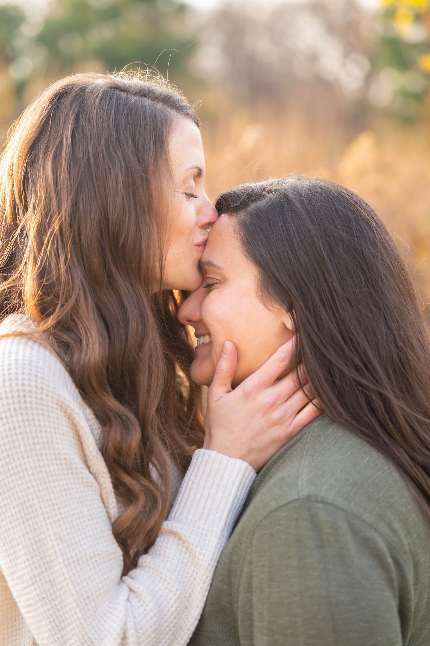 Intimate moment between two people with warm sunset lighting in a natural setting.