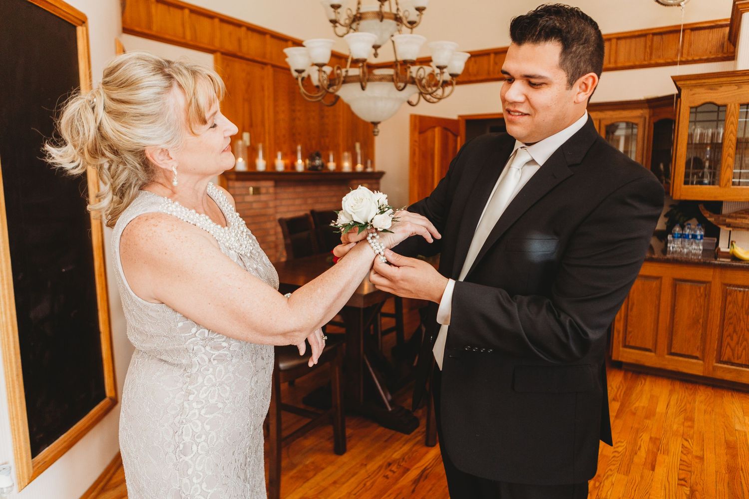 Groom puts on the boutineirre during the Loveland Wedding.