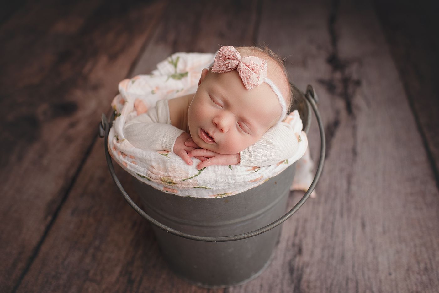 Baby girl in a bucket in a Perth newborn photography studio