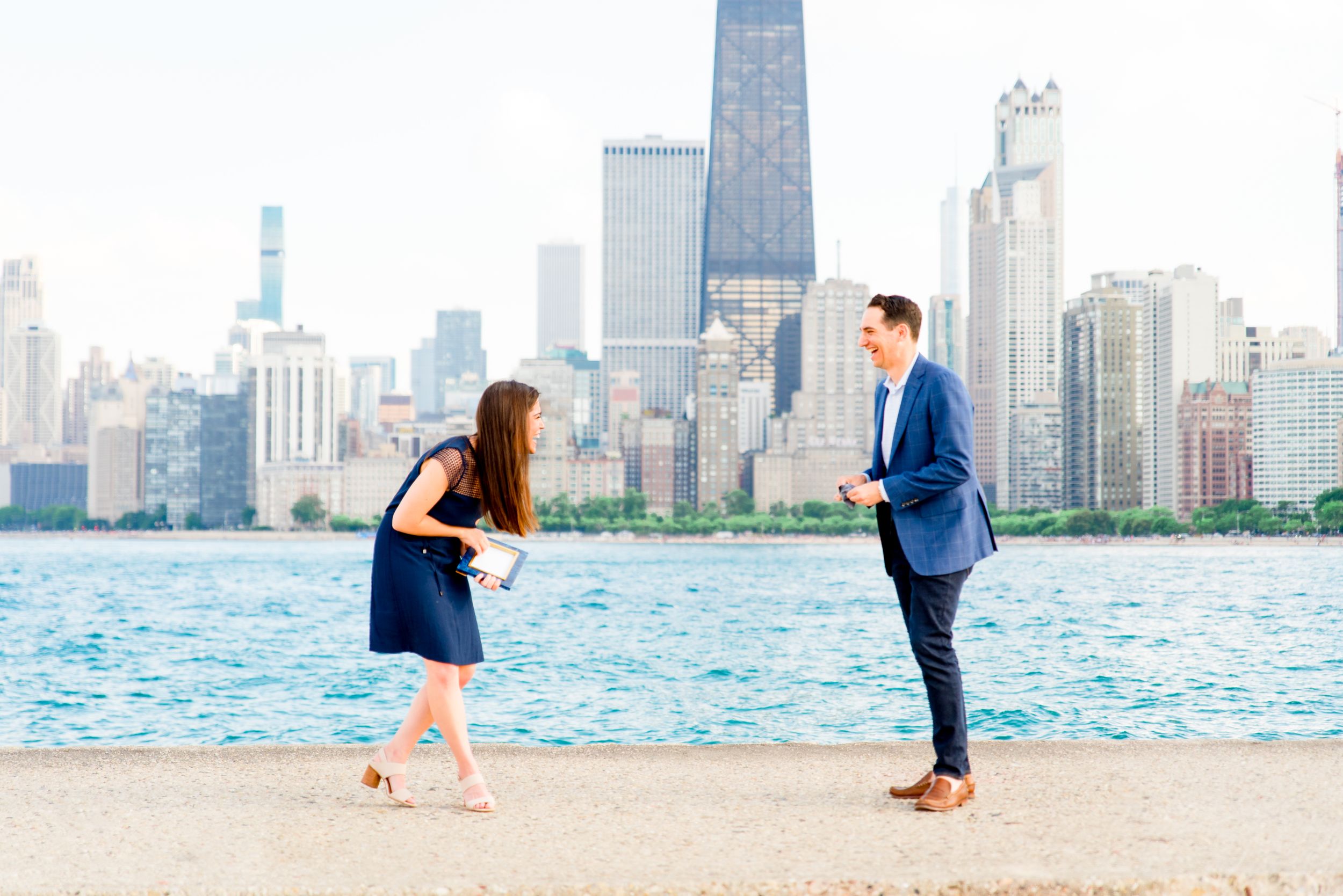 man and woman laughing before North Avenue Beach proposal in Chicago