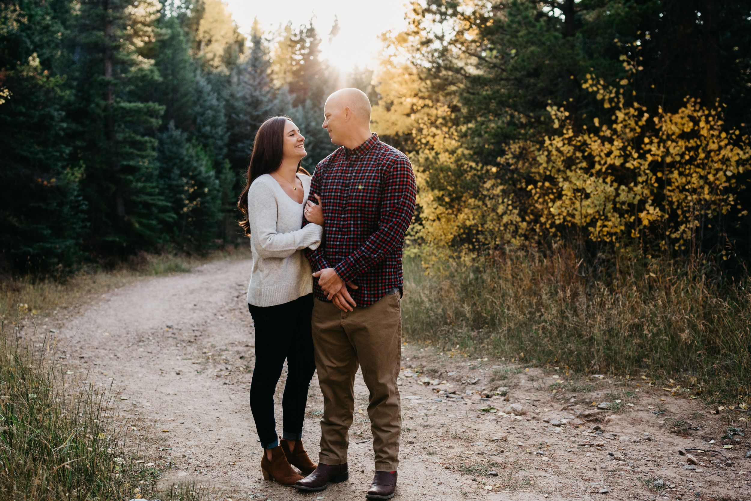Sun flare and beautiful light sunset engagement session Evergreen, Colorado