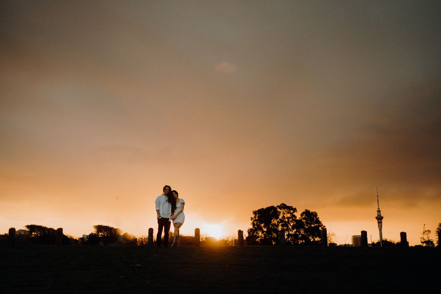 Couple in their engagement shoot at sunset in Auckland Museum with Apertured Media-Auckland Wedding Photographer