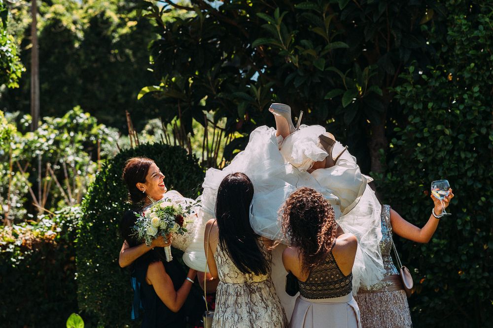 Amigas da noiva, a pegarem na noiva a a lançar ao ar.