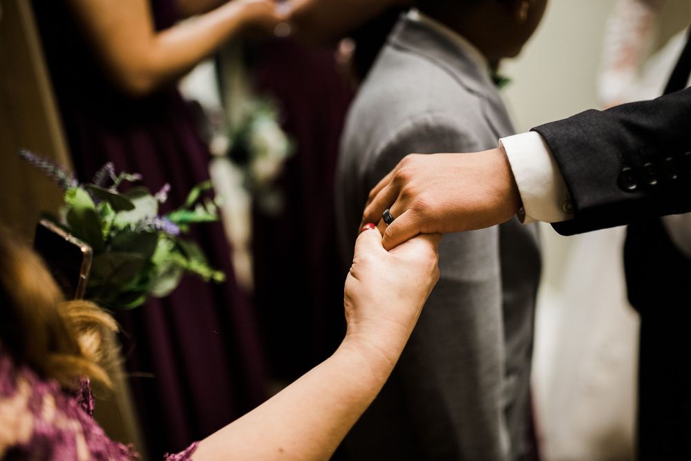 Bridesmaid looks at groom's new ring by Hudson Valley wedding photographer