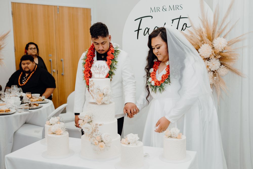 Couple participates in ceremonial sand pouring during wedding ceremony.