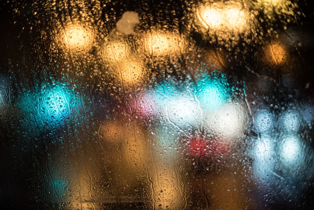 Colorful lights through a windshield on a rainy London evening