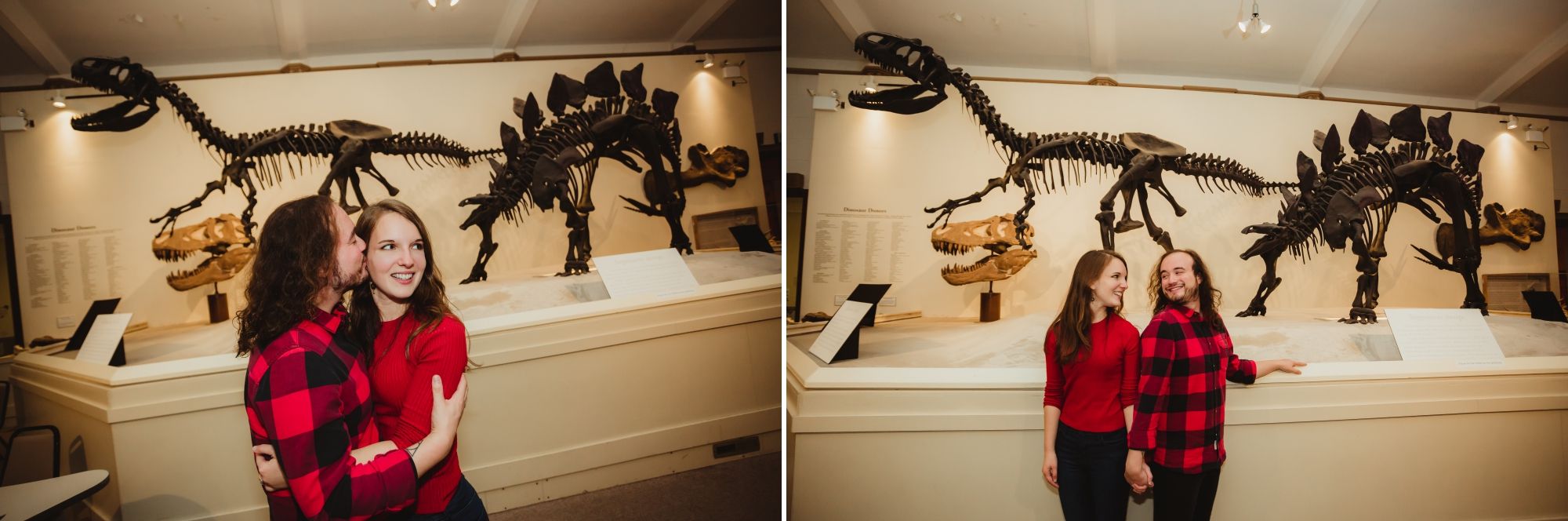 Man and woman with brown hair and red shirts standing together embracing in front of dinosaur skeletons.