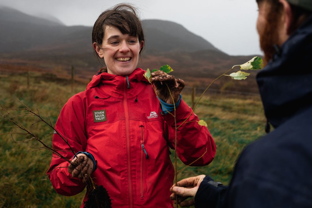 Izzy Isobel Filor of the John Muir Trust teaching tree planting with a birch tree to rewild and regenerate woodland