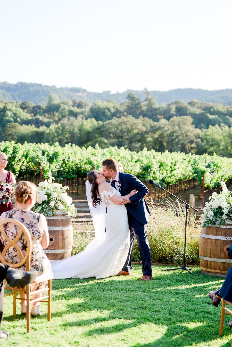bride and groom's first kiss in front of mountains at outdoor Pennyroyal Farm wedding