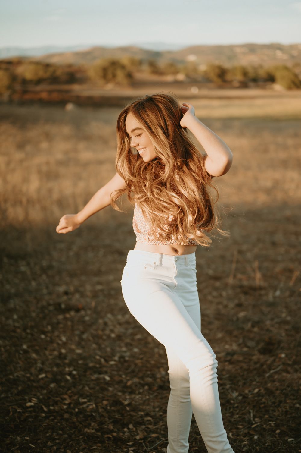 High School Senior photo by Tiffany Kelterer, San Diego portrait photographer of girl laughing and jumping