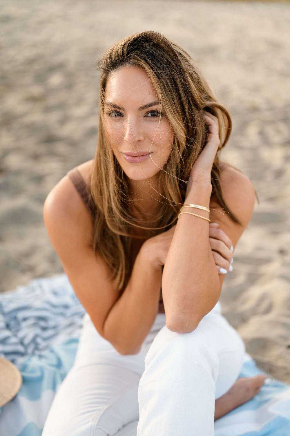 Lifestyle senior portrait by San Diego Photographer Tiffany Kelterer of woman sitting in sand on Coronado Beach