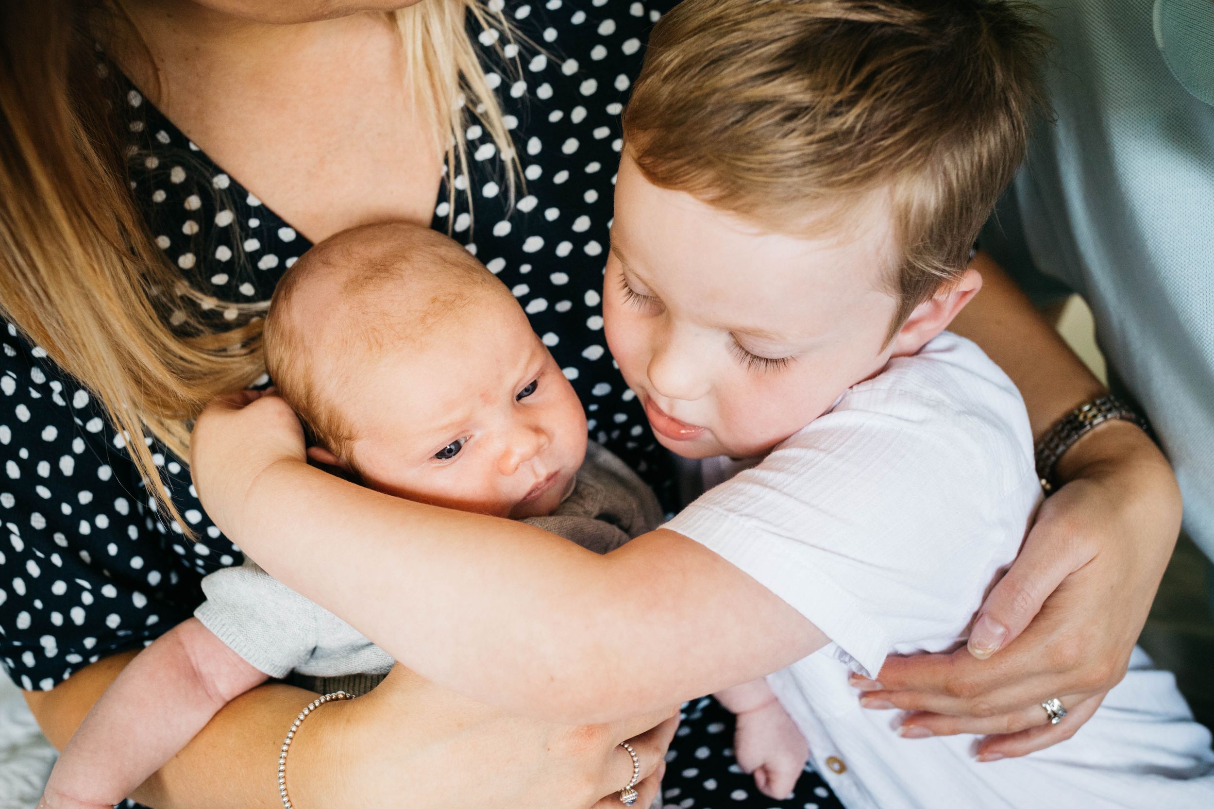 big brother hugging little baby brother