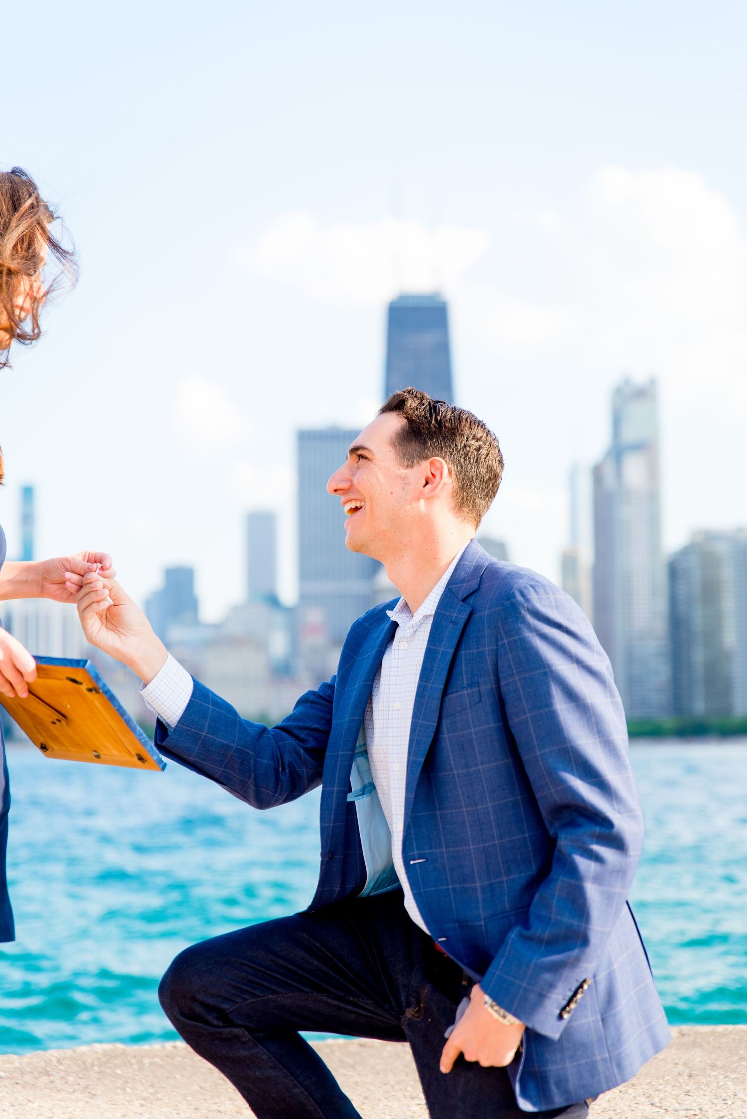 man holding ring during proposal at North avenue beach
