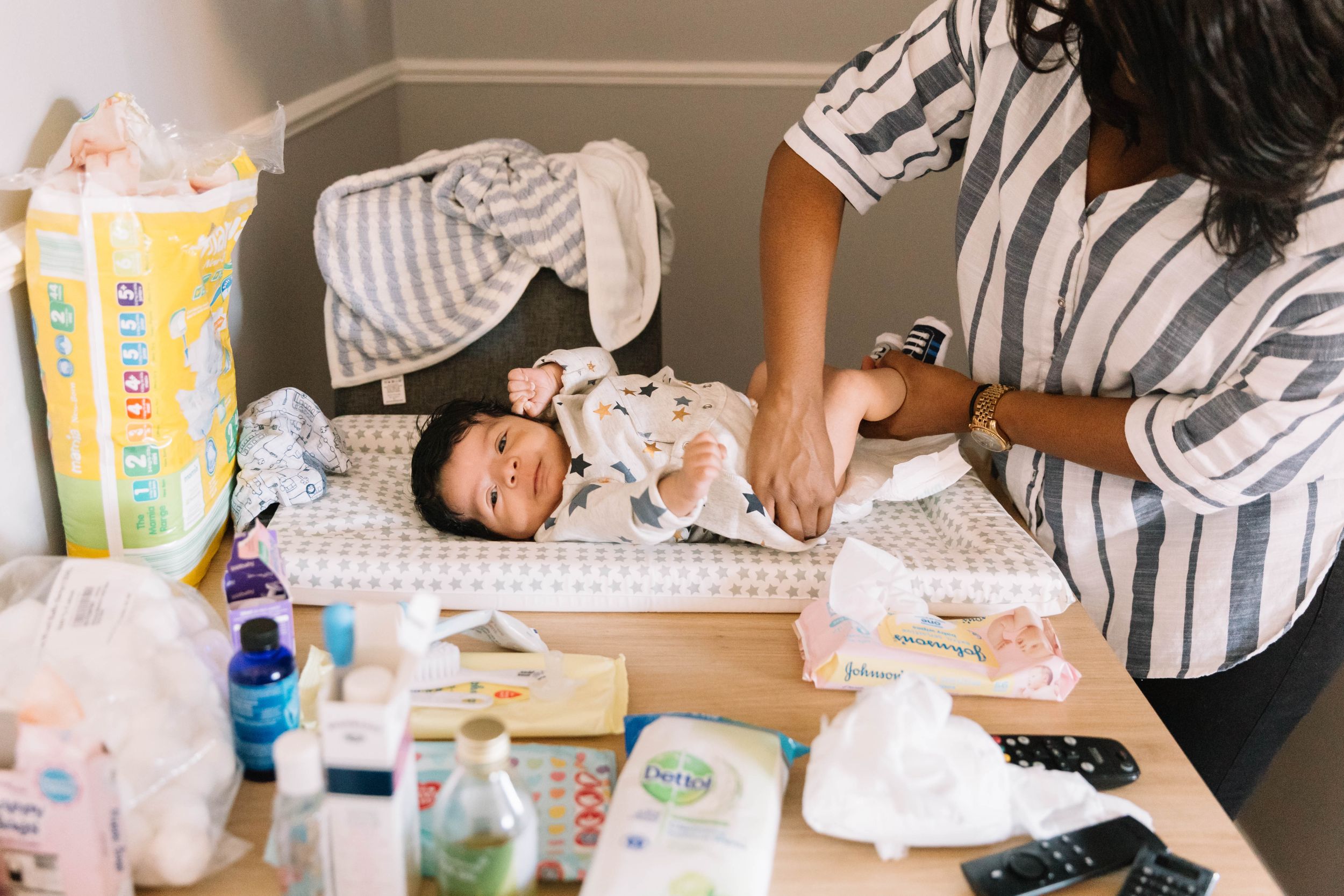 mum changing nappy 7 week old baby