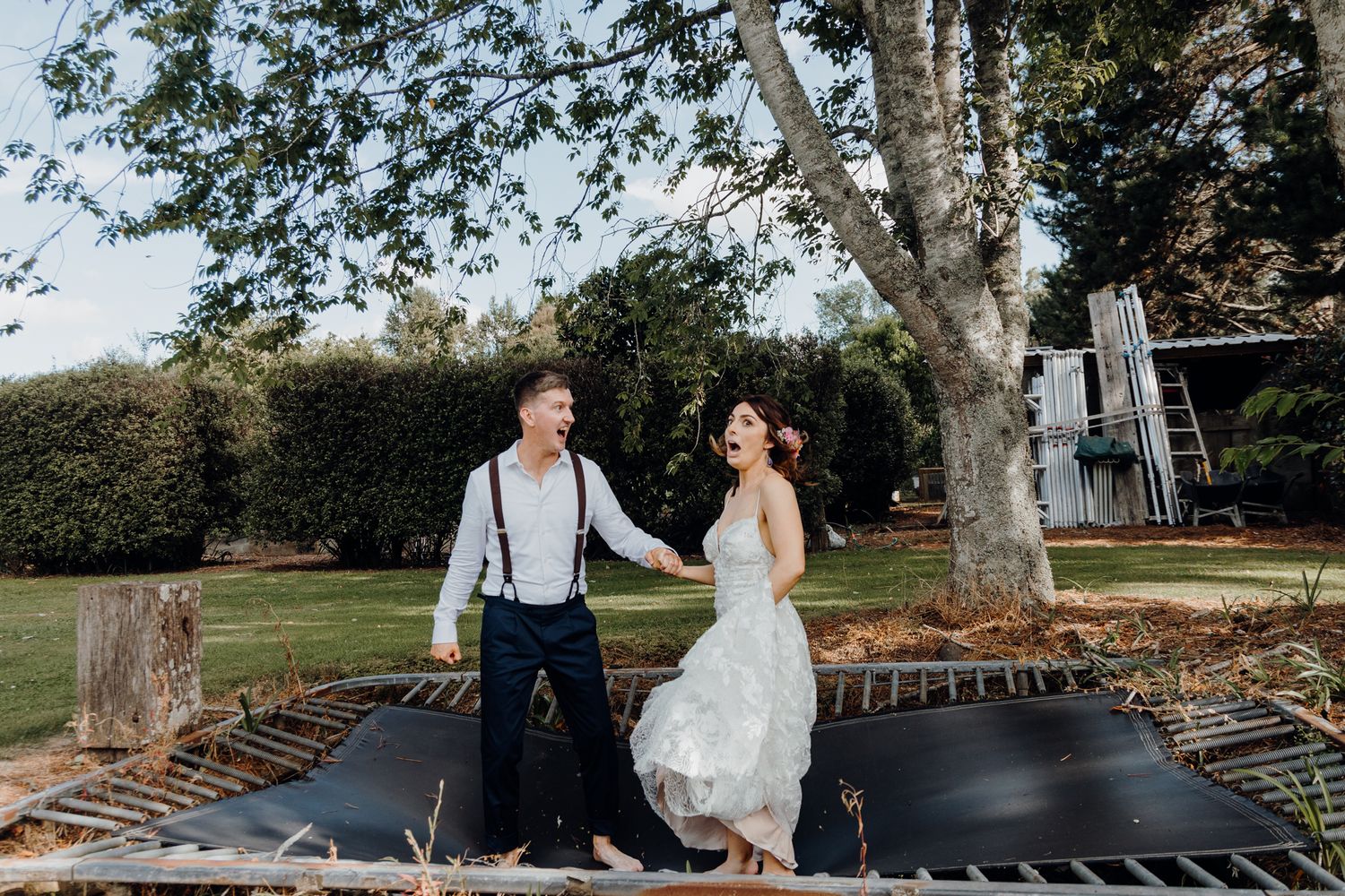 Newly weds enjoying the trampoline on their wedding photoshoot with Apertured Media Auckland Wedding Photographer.