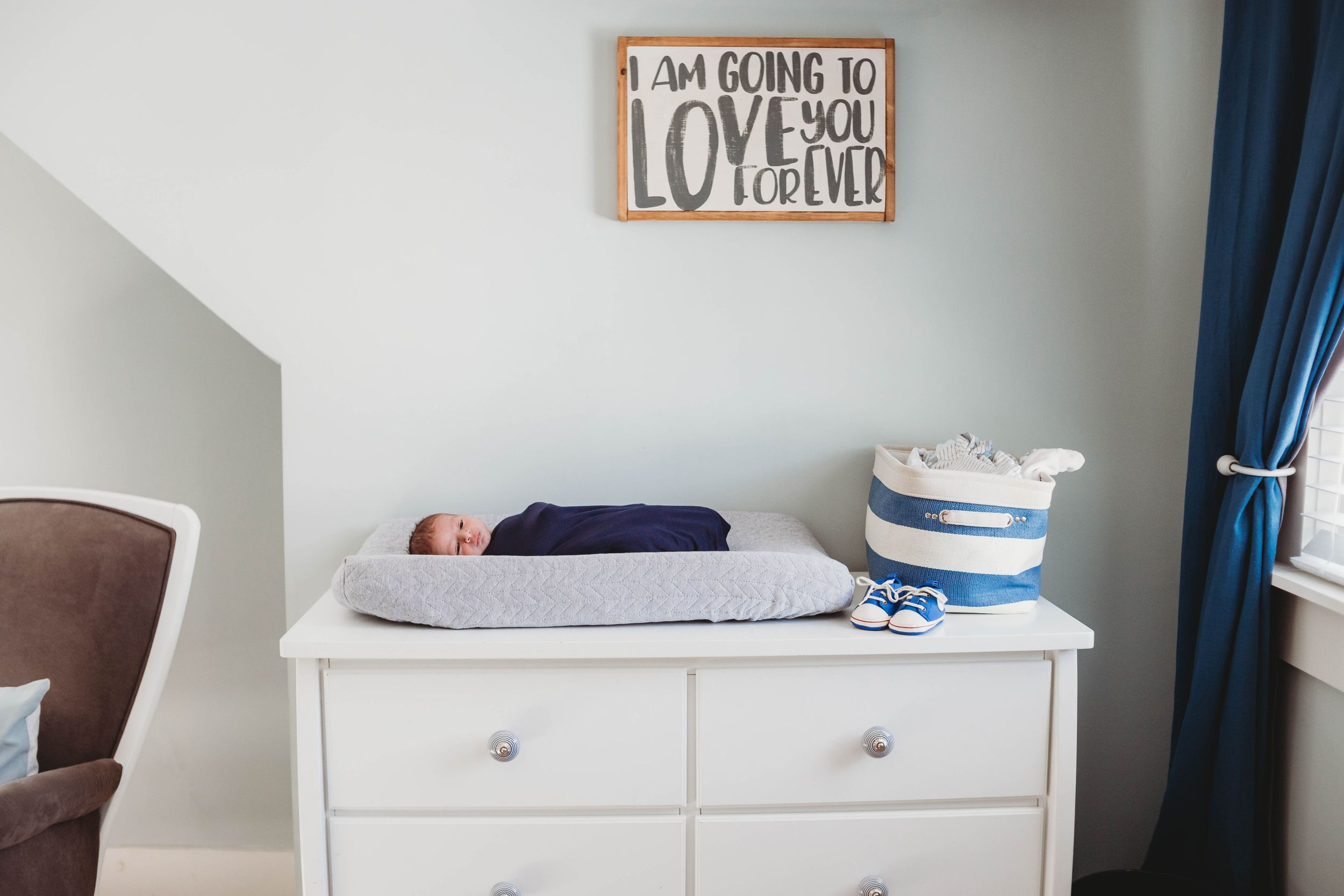 newborn on changing table by leominster newborn photographer