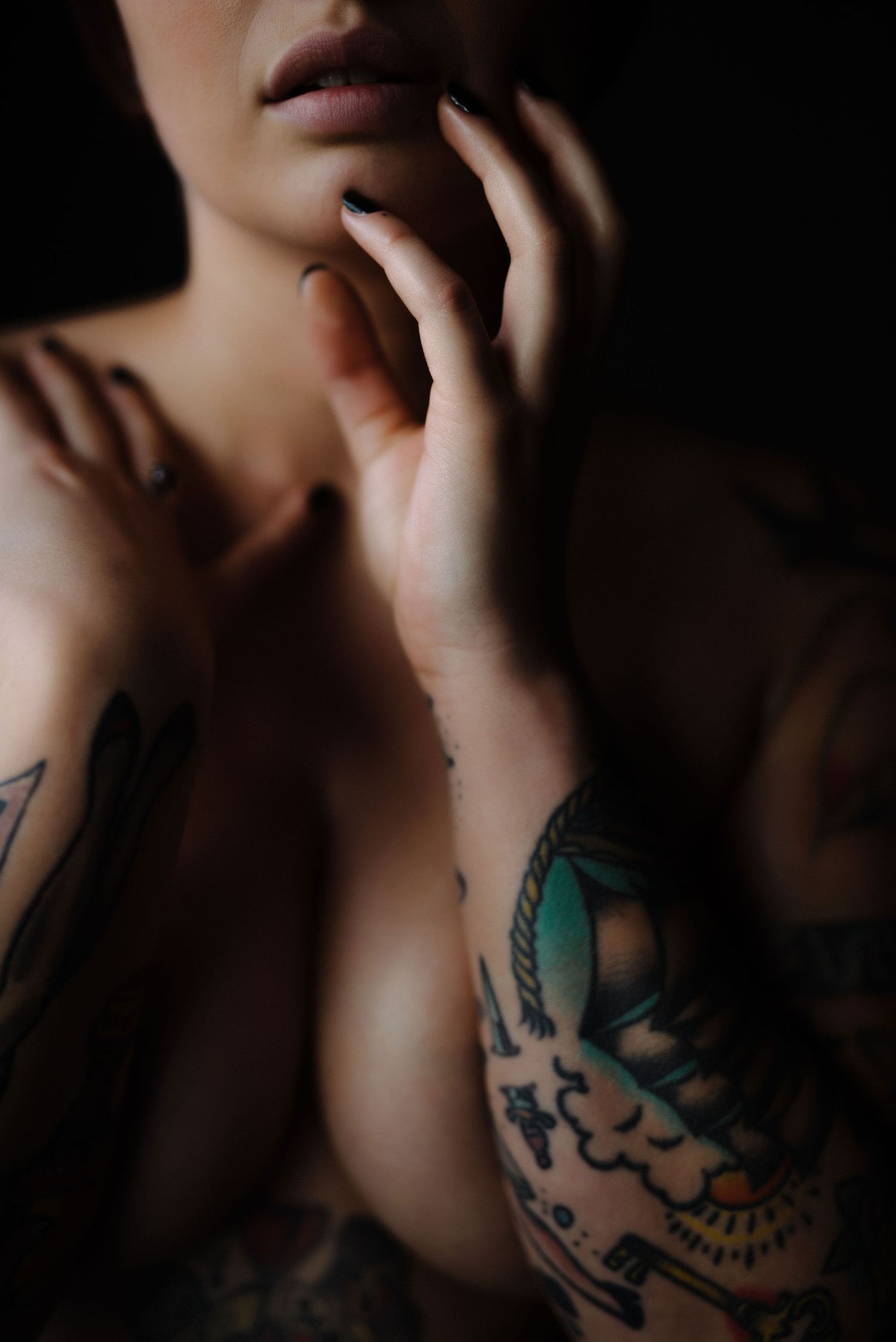 hands on lips, light fair skin with tattoos all over
