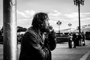 Black and white image of man smoking cigarette in Moscow Russia